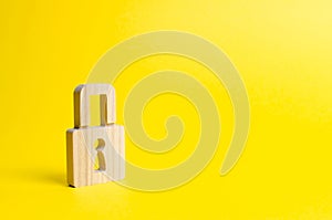 A padlock on a yellow background. information safty. concept of the preservation of secrets, information and values. Hacking