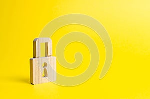 A padlock on a yellow background. information safty. concept of the preservation of secrets, information and values. Hacking photo