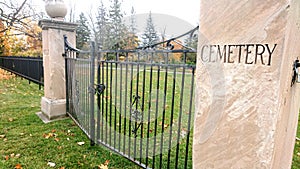 Padlocked gates to a cemetary with black iron