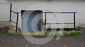 Padlocked metal entrance door to the basement