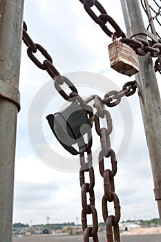 Padlocks And Chains Secure Gate To Industrial Work Site