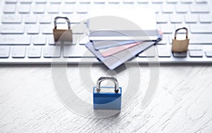 Padlocks with credit cards on the computer keyboard