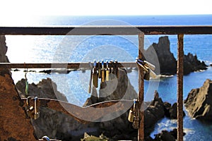 Padlocks hanging on Reef of the Sirens railing in Cabo de Gata