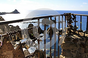 Padlocks hanging on Reef of the Sirens railing in Cabo de Gata