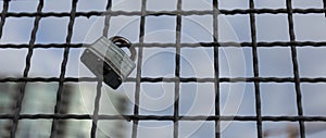 Padlocks hanging on a wire rope. Love locks on netting fence at the brigde in New Wesminster BC photo