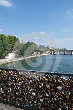 Padlocks love locks in bridge over River Seine in Paris, France