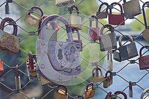 Padlocks love locks on a bridge railing