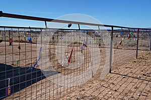 Padlocks, love locks, and keychains on a wire fence in the desert