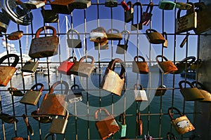 Padlocks of love on welded wire fence at marina with sailboats in Silo Park, Auckland, New Zealand
