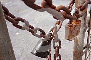 Padlocks And Rusted Chains Secure Gate At Industrial Site