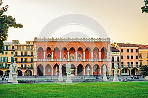 Padua cityscape with Palazzo Loggia Amulea palace neogothic style building and statues near small canal