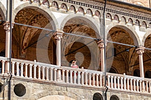 Padua -  Tourist woman enjoying the view on Piazza delle Erbe from the loggia of Palazzo della Ragione in Padua, Veneto, Italy