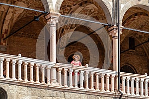 Padua -  Tourist woman enjoying the view on Piazza delle Erbe from the loggia of Palazzo della Ragione in Padua, Veneto, Italy