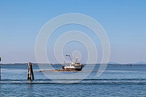 Padua - Wrack of fishing boat stranded in Venetian lagoon seen from the island of Pellestrina near Venice