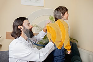 Paediatrician doctor examining a child in comfortabe medical office