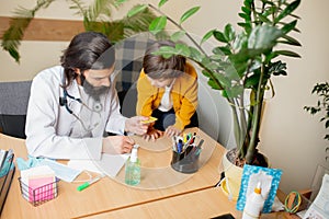 Paediatrician doctor examining a child in comfortabe medical office