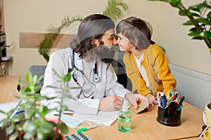 Paediatrician doctor examining a child in comfortabe medical office