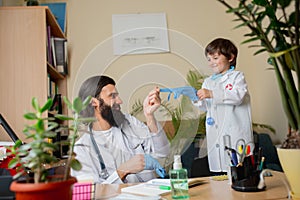 Paediatrician doctor examining a child in comfortabe medical office