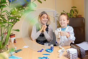 Paediatrician doctor examining a child in comfortabe medical office. Little girl playing pretends like doctor for woman