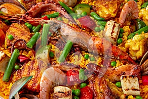 Paella. Spanish dish of rice and seafood, vegetables and chicken. Shrimp, octopus, crab and mussels. Banquet festive dishes.