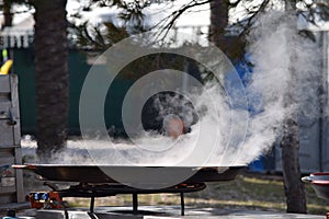 Paellera on the fire for the preparation of paella. photo