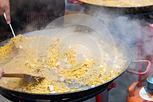 Paellera with Valencian seafood fideua prepared during street festival