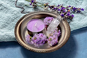 Pagan ritual. A purple candle, a crystal charm, and flowers, vervain and lavender