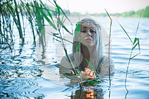 Pagan scene in lake, magical rituals photo