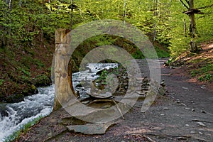Pagan stone images in mountains, Carpathian whaterfall photo