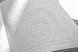Page of book with Braille text, closeup.