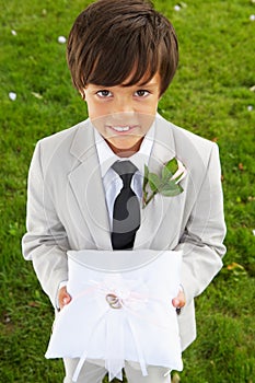 Page Boy Carrying Wedding Ring On Cushion