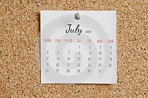 Page from calendar for full month: June 2021. White sheet with dates is pinned to cork board. Concept of calendar date photo