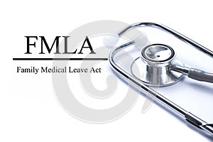 Page with FMLA family medical leave act on the table with stethoscope, medical concept