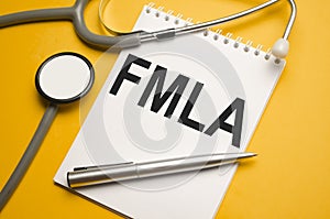 Page with FMLA Family Medical Leave Act on the table with stethoscope, medical concept