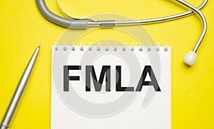 Page with FMLA Family Medical Leave Act on the table with stethoscope