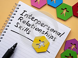 Page with inscription Interpersonal Relationships skills and figurines.