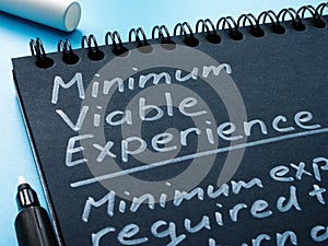 Page of notepad with sign Minimum Viable Experience MVE.