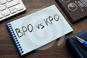 Page with written words BPO vs KPO and pen.