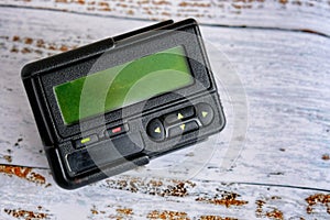 Pager or beeper on light wood background photo