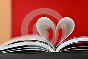 Pages of a book curved into a heart shape