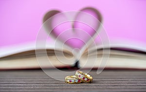 Pages of book curved heart shape and weeding ring