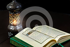 Pages of holy book Qur`an with vintage lamp