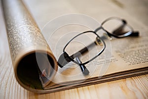 On the pages of an open magazine are glasses