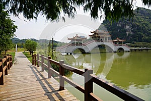 Pagoda bridge across the lake in the park. Seven Stars Cave Scenic Park in Zhaoqing City