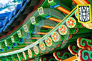 Pagoda. Close-up fragment of a bright wooden gazebo in the garden. Multicolored pattern.