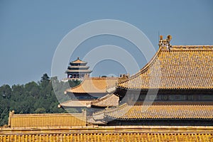 Pagoda on a hill with traditional Chinese roofs in foreground