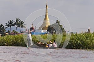 Pagoda at Inle lake and people on boat