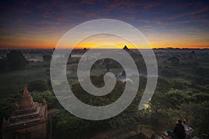 Pagoda landscape of Bagan in misty morning under a warm sunrise in the plain of Bagan Myanmar.