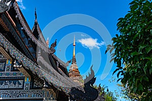 Pagoda and Lanna style dark wooden church at Wat Lok Molee