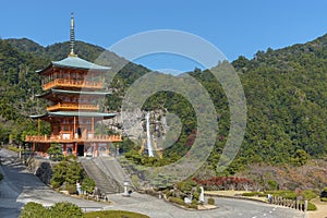 Scenic view of pagoda of Seiganto-ji Temple with Nachi no Taki waterfall in background at Nachi Katsuura, Wakayama, Japan